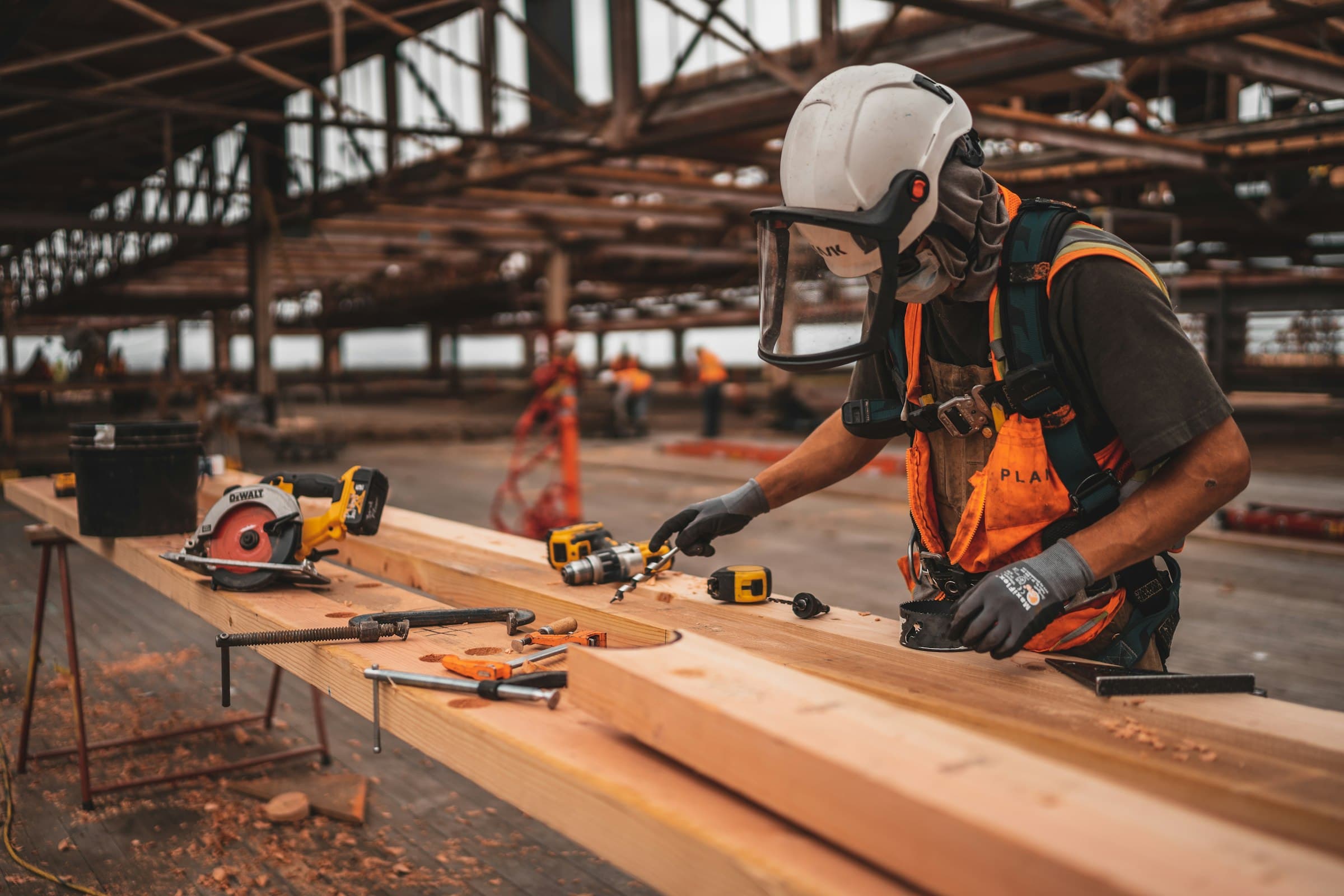Carpenter at work on a beam in his workshop
